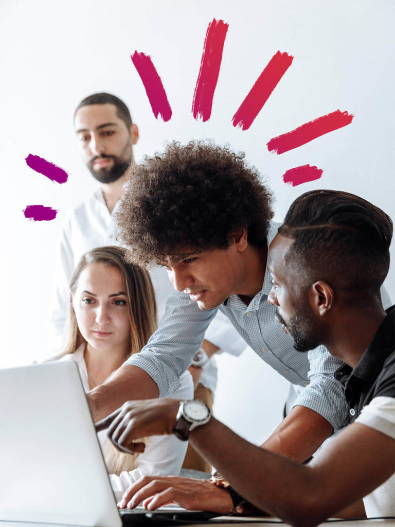 Team sharing ideas around a computer