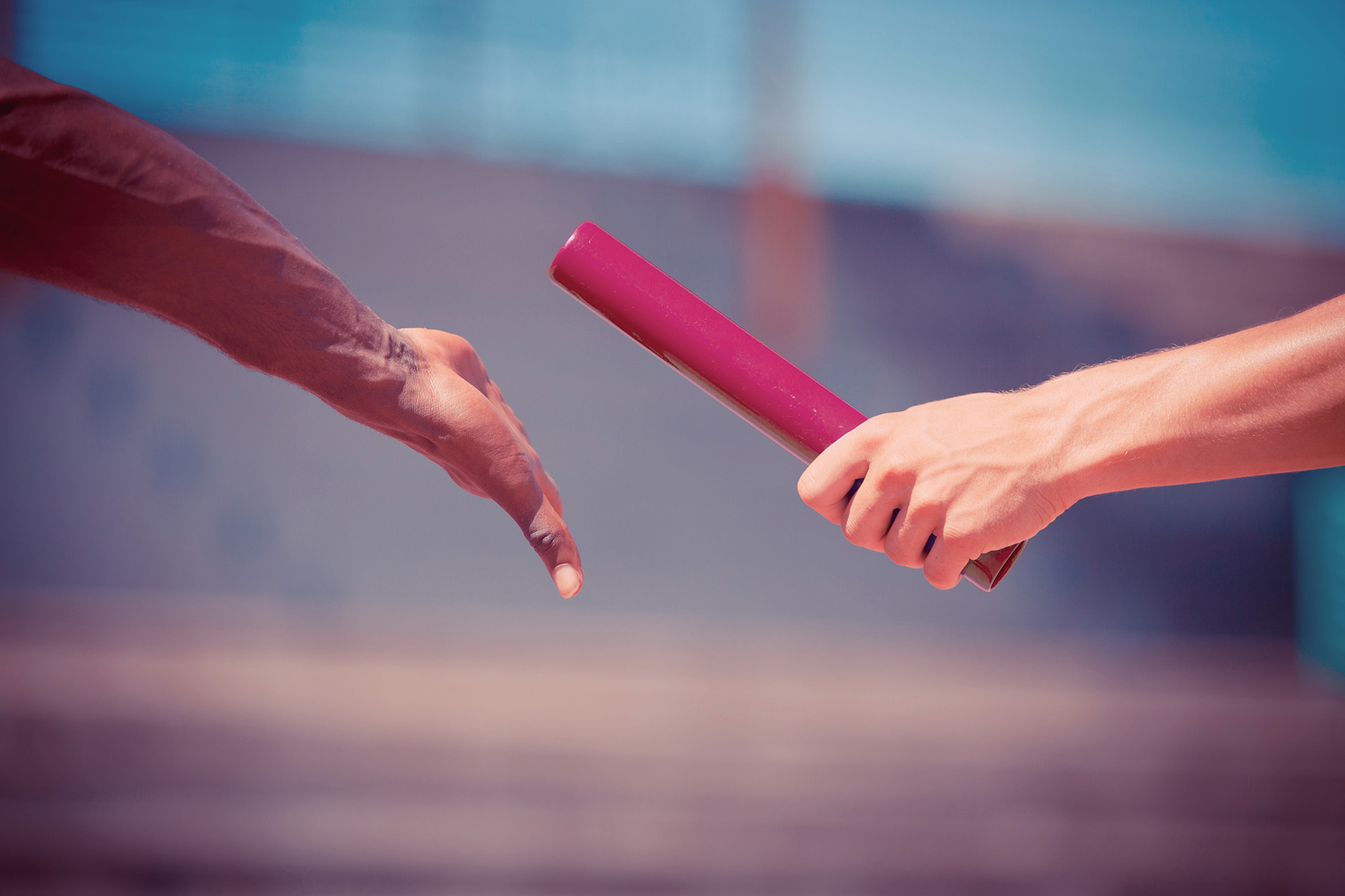 Hands passing a baton